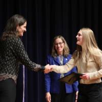 awardee at the stage with jenn